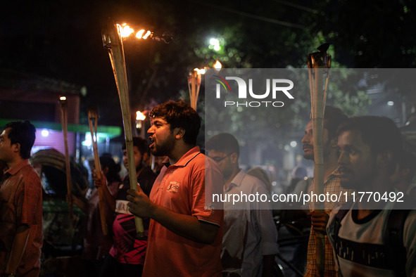 The Bangladesh Students Union holds a torch procession protesting the murder of a female ready-made garment worker and demanding justice at...