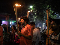 The Bangladesh Students Union holds a torch procession protesting the murder of a female ready-made garment worker and demanding justice at...