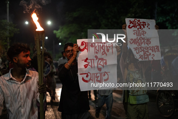 The Bangladesh Students Union holds a torch procession protesting the murder of a female ready-made garment worker and demanding justice at...