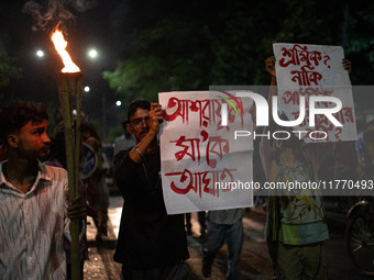 The Bangladesh Students Union holds a torch procession protesting the murder of a female ready-made garment worker and demanding justice at...