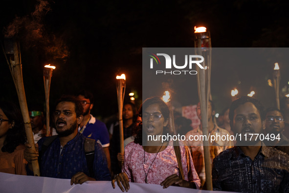 The Bangladesh Students Union holds a torch procession protesting the murder of a female ready-made garment worker and demanding justice at...