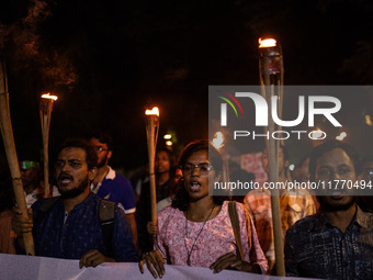 The Bangladesh Students Union holds a torch procession protesting the murder of a female ready-made garment worker and demanding justice at...