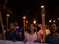 The Bangladesh Students Union holds a torch procession protesting the murder of a female ready-made garment worker and demanding justice at...