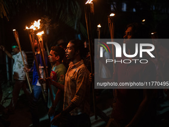 The Bangladesh Students Union holds a torch procession protesting the murder of a female ready-made garment worker and demanding justice at...