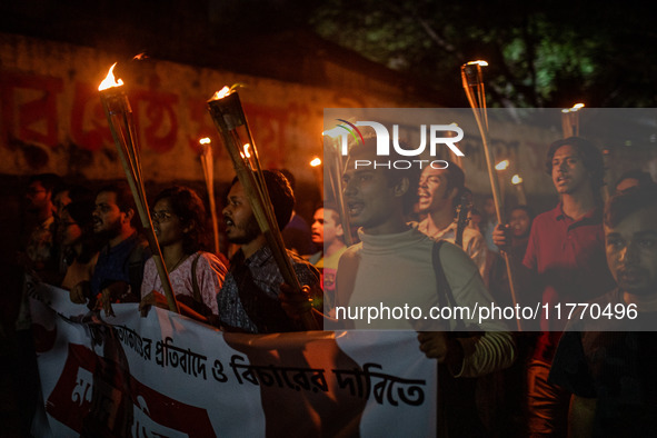 The Bangladesh Students Union holds a torch procession protesting the murder of a female ready-made garment worker and demanding justice at...