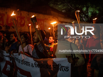 The Bangladesh Students Union holds a torch procession protesting the murder of a female ready-made garment worker and demanding justice at...