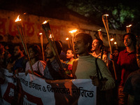 The Bangladesh Students Union holds a torch procession protesting the murder of a female ready-made garment worker and demanding justice at...