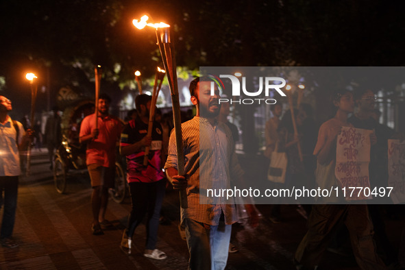 The Bangladesh Students Union holds a torch procession protesting the murder of a female ready-made garment worker and demanding justice at...