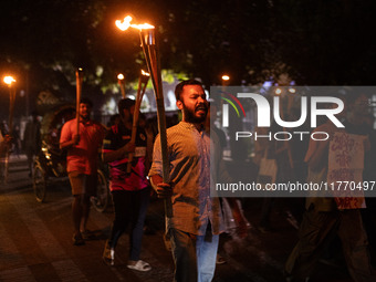 The Bangladesh Students Union holds a torch procession protesting the murder of a female ready-made garment worker and demanding justice at...