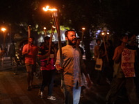 The Bangladesh Students Union holds a torch procession protesting the murder of a female ready-made garment worker and demanding justice at...