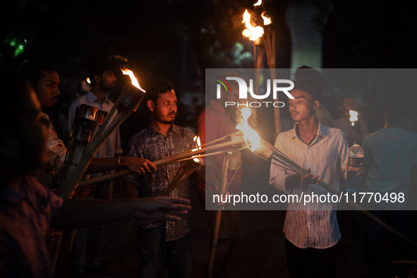 The Bangladesh Students Union holds a torch procession protesting the murder of a female ready-made garment worker and demanding justice at...