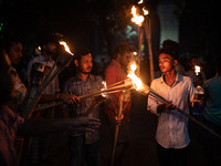 The Bangladesh Students Union holds a torch procession protesting the murder of a female ready-made garment worker and demanding justice at...