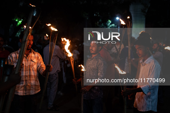 The Bangladesh Students Union holds a torch procession protesting the murder of a female ready-made garment worker and demanding justice at...