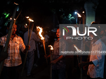 The Bangladesh Students Union holds a torch procession protesting the murder of a female ready-made garment worker and demanding justice at...