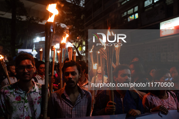 The Bangladesh Students Union holds a torch procession protesting the murder of a female ready-made garment worker and demanding justice at...