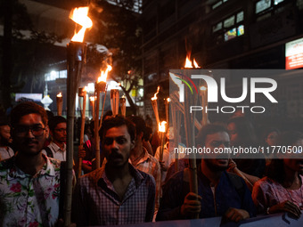 The Bangladesh Students Union holds a torch procession protesting the murder of a female ready-made garment worker and demanding justice at...