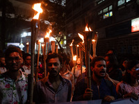 The Bangladesh Students Union holds a torch procession protesting the murder of a female ready-made garment worker and demanding justice at...