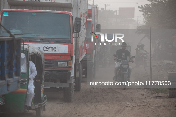 People suffer on the street due to massive dust in the air in the Shyampur area, in Dhaka, Bangladesh, on November 12, 2024. Dhaka, the over...