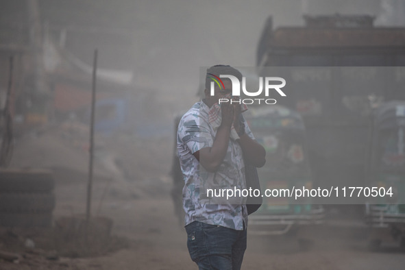 People suffer on the street due to massive dust in the air in the Shyampur area, in Dhaka, Bangladesh, on November 12, 2024. Dhaka, the over...