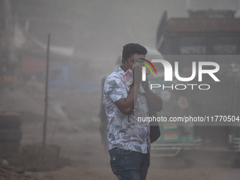 People suffer on the street due to massive dust in the air in the Shyampur area, in Dhaka, Bangladesh, on November 12, 2024. Dhaka, the over...