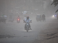 People suffer on the street due to massive dust in the air in the Shyampur area, in Dhaka, Bangladesh, on November 12, 2024. Dhaka, the over...