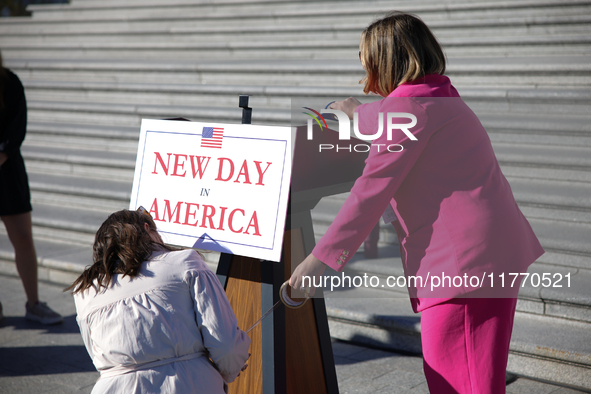 Aides affix a sign reading 'New Day in America' to a podium before a GOP press conference on the steps of the U.S. Capitol in Washington, D....