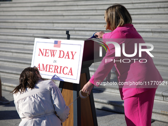 Aides affix a sign reading 'New Day in America' to a podium before a GOP press conference on the steps of the U.S. Capitol in Washington, D....