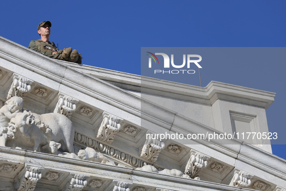 A law enforcement officer watches from the rooftop of the U.S. Capitol in Washington, D.C. on November 12, 2024, prior to a GOP press confer...