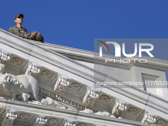 A law enforcement officer watches from the rooftop of the U.S. Capitol in Washington, D.C. on November 12, 2024, prior to a GOP press confer...