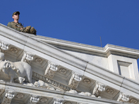 A law enforcement officer watches from the rooftop of the U.S. Capitol in Washington, D.C. on November 12, 2024, prior to a GOP press confer...