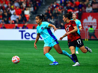 M. Fowler #11 carries the ball while guarded by J. Fleming #17 during the International Friendly Match between Canada and Australia in Vanco...