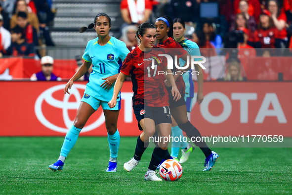 J. Fleming #17 carries the ball while guarded by M. Fowler #11 during the International Friendly Match between Canada and Australia at BC Pl...