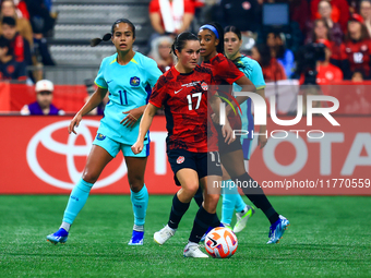 J. Fleming #17 carries the ball while guarded by M. Fowler #11 during the International Friendly Match between Canada and Australia at BC Pl...