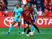 J. Fleming #17 carries the ball while guarded by M. Fowler #11 during the International Friendly Match between Canada and Australia at BC Pl...