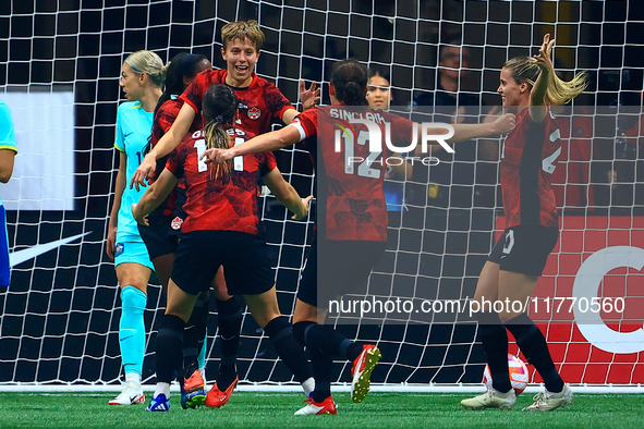 In Vancouver, Canada, on December 5, 2023, Quinn #5 and other Canadian players celebrate a goal during the International Friendly Match betw...