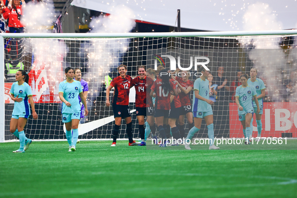 In Vancouver, Canada, on December 5, 2023, Quinn #5 and other Canadian players celebrate a goal during the International Friendly Match betw...