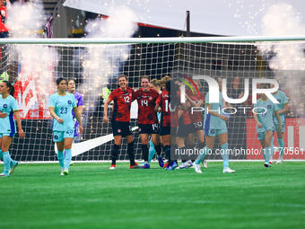 In Vancouver, Canada, on December 5, 2023, Quinn #5 and other Canadian players celebrate a goal during the International Friendly Match betw...