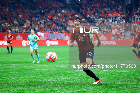 C. Sinclair #12 chases the ball during the International Friendly Match between Canada and Australia in Vancouver, Canada, on December 5, 20...