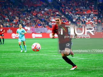 C. Sinclair #12 chases the ball during the International Friendly Match between Canada and Australia in Vancouver, Canada, on December 5, 20...