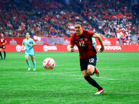 C. Sinclair #12 chases the ball during the International Friendly Match between Canada and Australia in Vancouver, Canada, on December 5, 20...