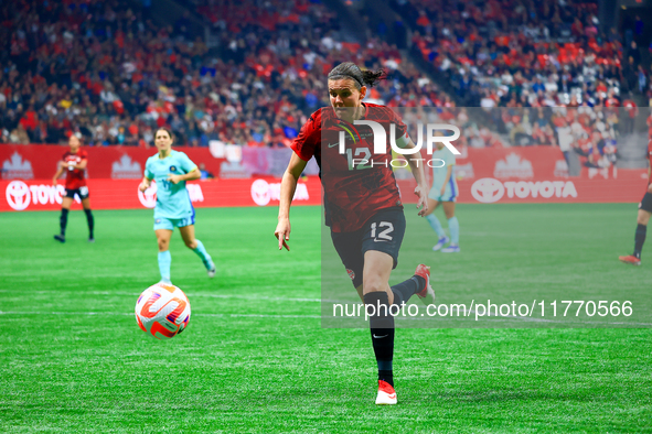 C. Sinclair #12 chases the ball during the International Friendly Match between Canada and Australia in Vancouver, Canada, on December 5, 20...