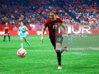 C. Sinclair #12 chases the ball during the International Friendly Match between Canada and Australia in Vancouver, Canada, on December 5, 20...