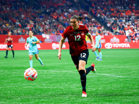 C. Sinclair #12 chases the ball during the International Friendly Match between Canada and Australia in Vancouver, Canada, on December 5, 20...