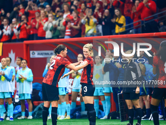 In Vancouver, Canada, on December 5, 2023, C. Sinclair, #12, passes the captain armband to S. Schmidt during the International Friendly Matc...