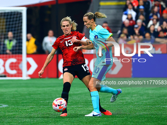 In Vancouver, Canada, on December 5, 2023, S. Schmidt #13 tries to steal the ball from van Egmond #10 during the International Friendly Matc...