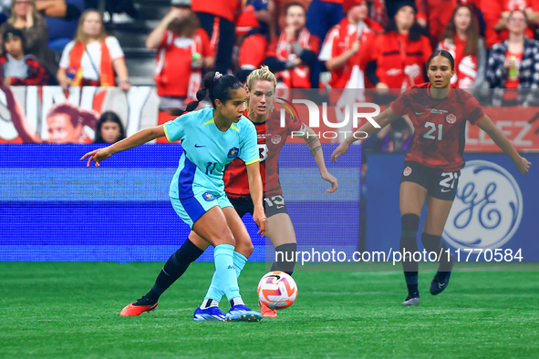 M. Fowler #11 controls the ball while guarded by S. Schmidt #13 and J. Rose #21 during the International Friendly Match between Canada and A...