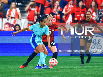 M. Fowler #11 controls the ball while guarded by S. Schmidt #13 and J. Rose #21 during the International Friendly Match between Canada and A...