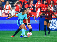 M. Fowler #11 controls the ball while guarded by S. Schmidt #13 and J. Rose #21 during the International Friendly Match between Canada and A...