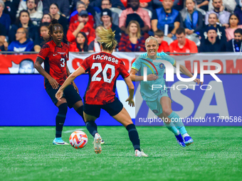 T. Yallop #13 chases the ball in front of C. Lacasse #20 during the International Friendly Match between Canada and Australia at BC Place in...