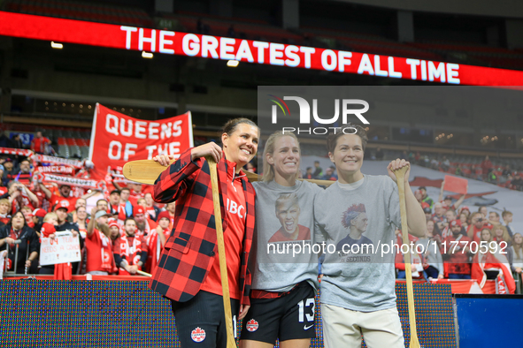 Sophie Schmidt, Christine Sinclair, and Erin McLeod take photos in front of fans during the International Friendly Match between Canada and...